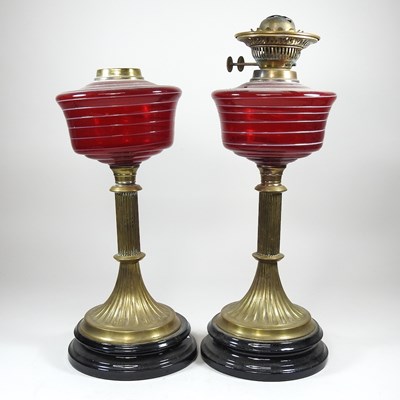 Lot 38 - A pair of ruby striped glass oil lamps