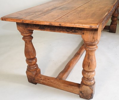 Lot 699 - An elm refectory table and chairs