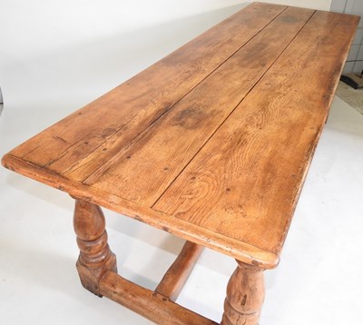 Lot 699 - An elm refectory table and chairs