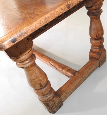 Lot 699 - An elm refectory table and chairs