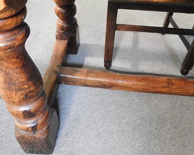 Lot 699 - An elm refectory table and chairs