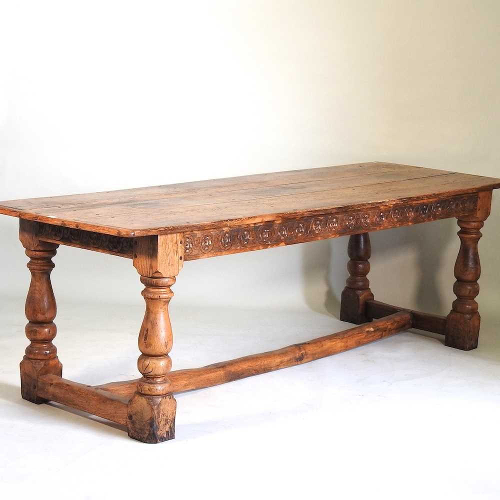 Lot 699 - An elm refectory table and chairs