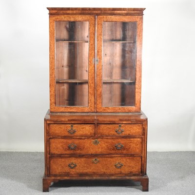 Lot 617 - A walnut bookcase on chest