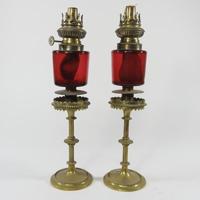 Lot 16 - A pair of ruby glass peg oil lamps