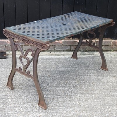 Lot 669 - A cast iron garden table