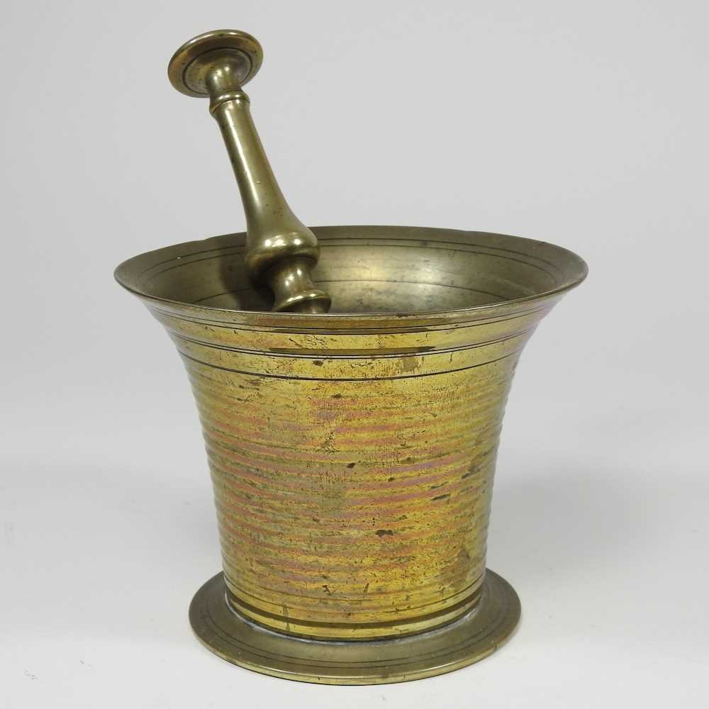 Lot 645 A brass pestle and mortar