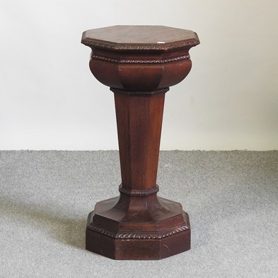 Lot 151 - A carved oak pedestal