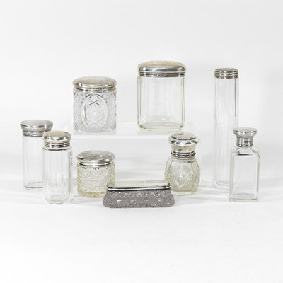 Lot 200 - A collection of silver top dressing table jars