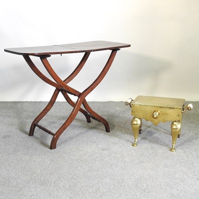 Lot 605 - A brass footman and table