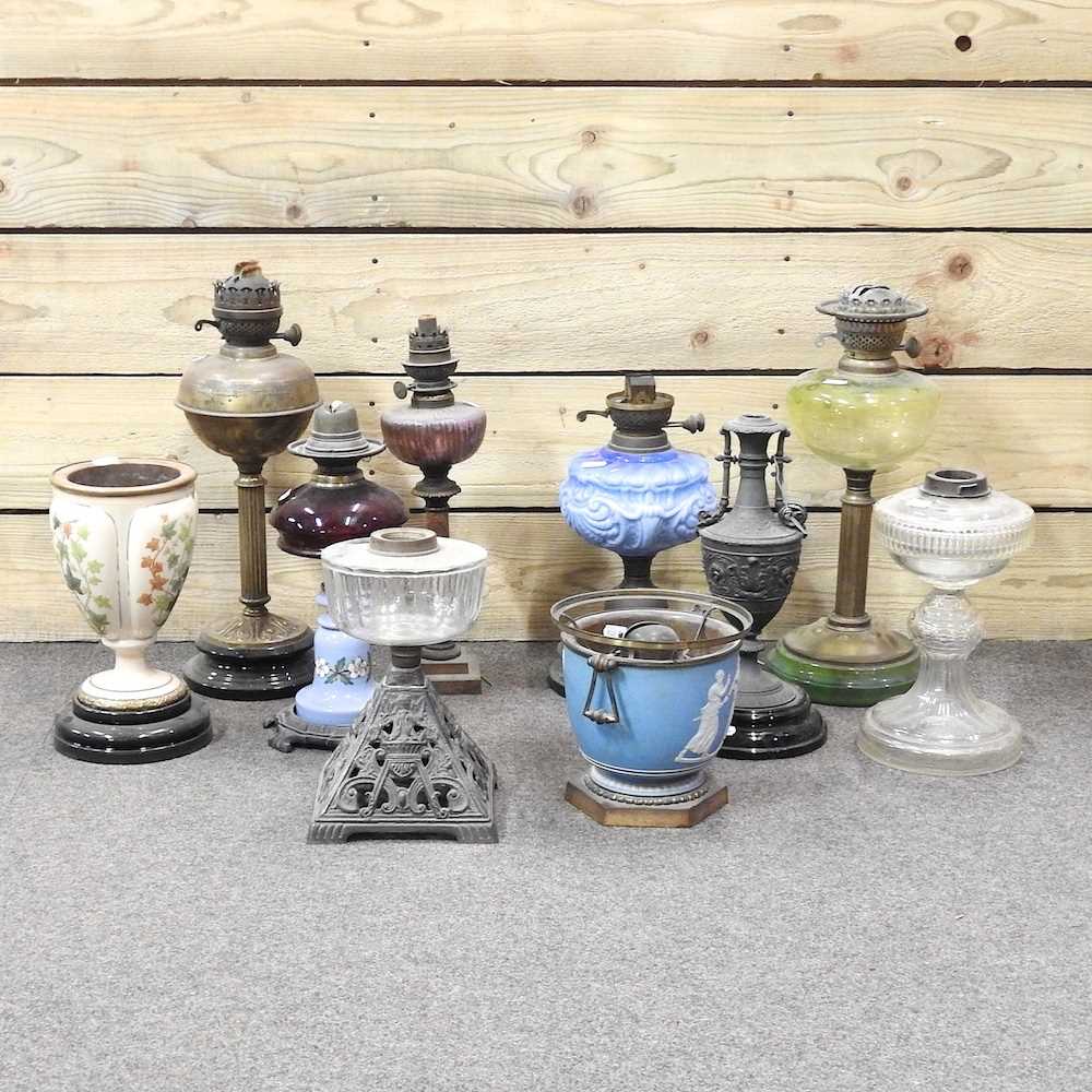 Lot 647 - A collection of ten oil lamps