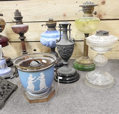 Lot 647 - A collection of ten oil lamps