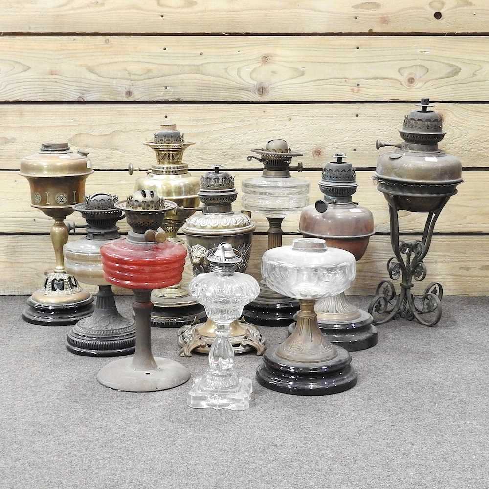 Lot 673 - A collection of ten oil lamp bases