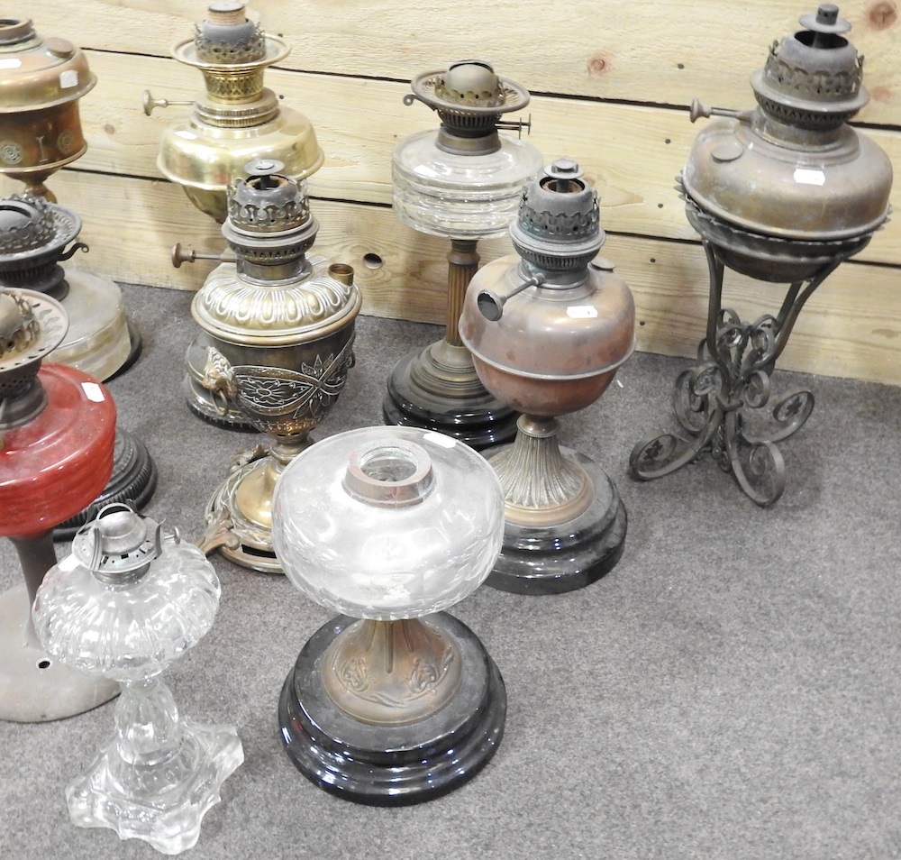 Lot 673 A collection of ten oil lamp bases