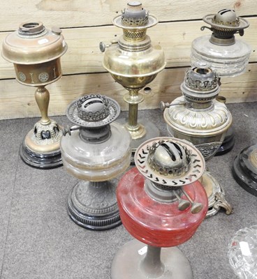 Lot 673 - A collection of ten oil lamp bases