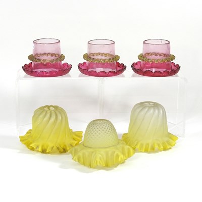 Lot 164 - A set of three cranberry glass shades