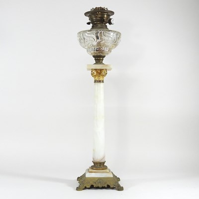 Lot 228 - An alabaster oil lamp with glass font