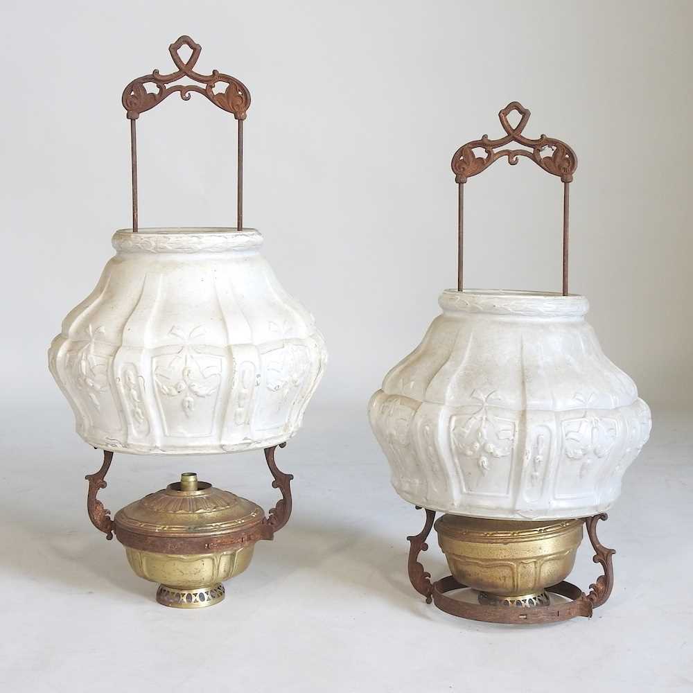 Lot 696 - A pair of hanging brass oil lamps