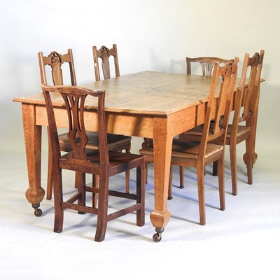 Lot 599 - An oak dining table and chairs