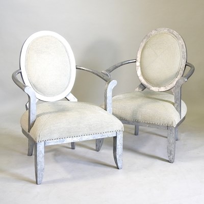 Lot 722 - A pair of silver painted and cream upholstered open armchairs