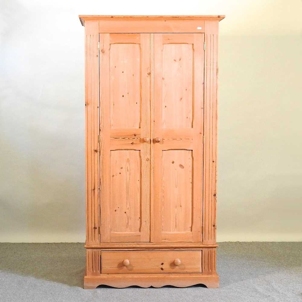 Lot 553 - A pine wardrobe