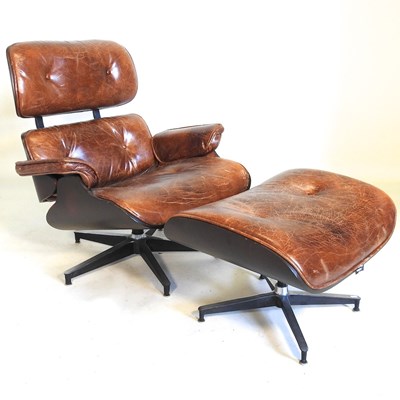 Lot 212 - An Eames design lounge chair and footstool