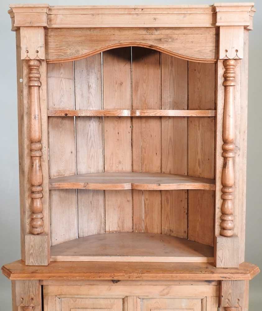 Lot 681 An antique pine corner cupboard