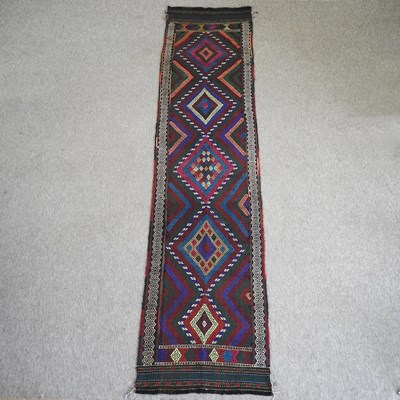 Lot 571 - A kelim runner