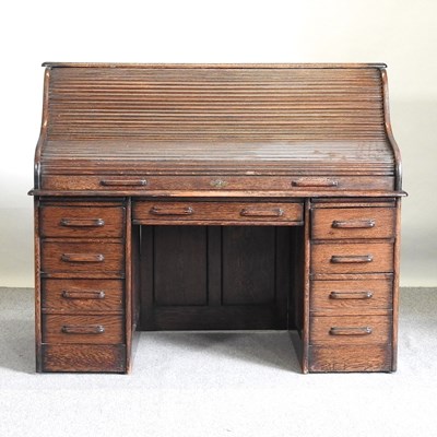 Lot 128 - An oak roll top desk