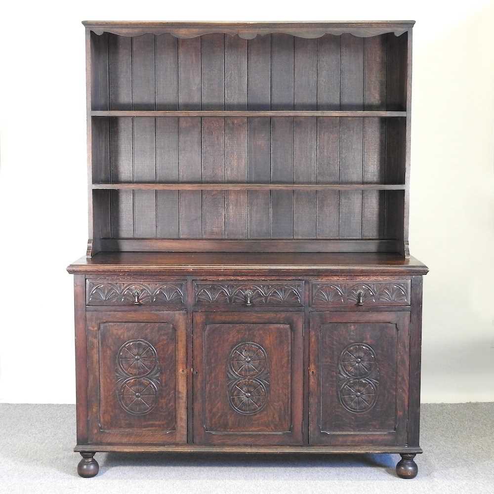 Lot 341 - A carved oak dresser