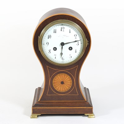 Lot 87 - An Edwardian mahogany cased balloon shaped mantel clock