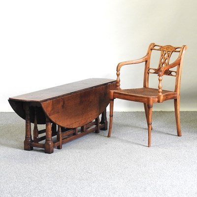 Lot 229 - A cane chair and a table