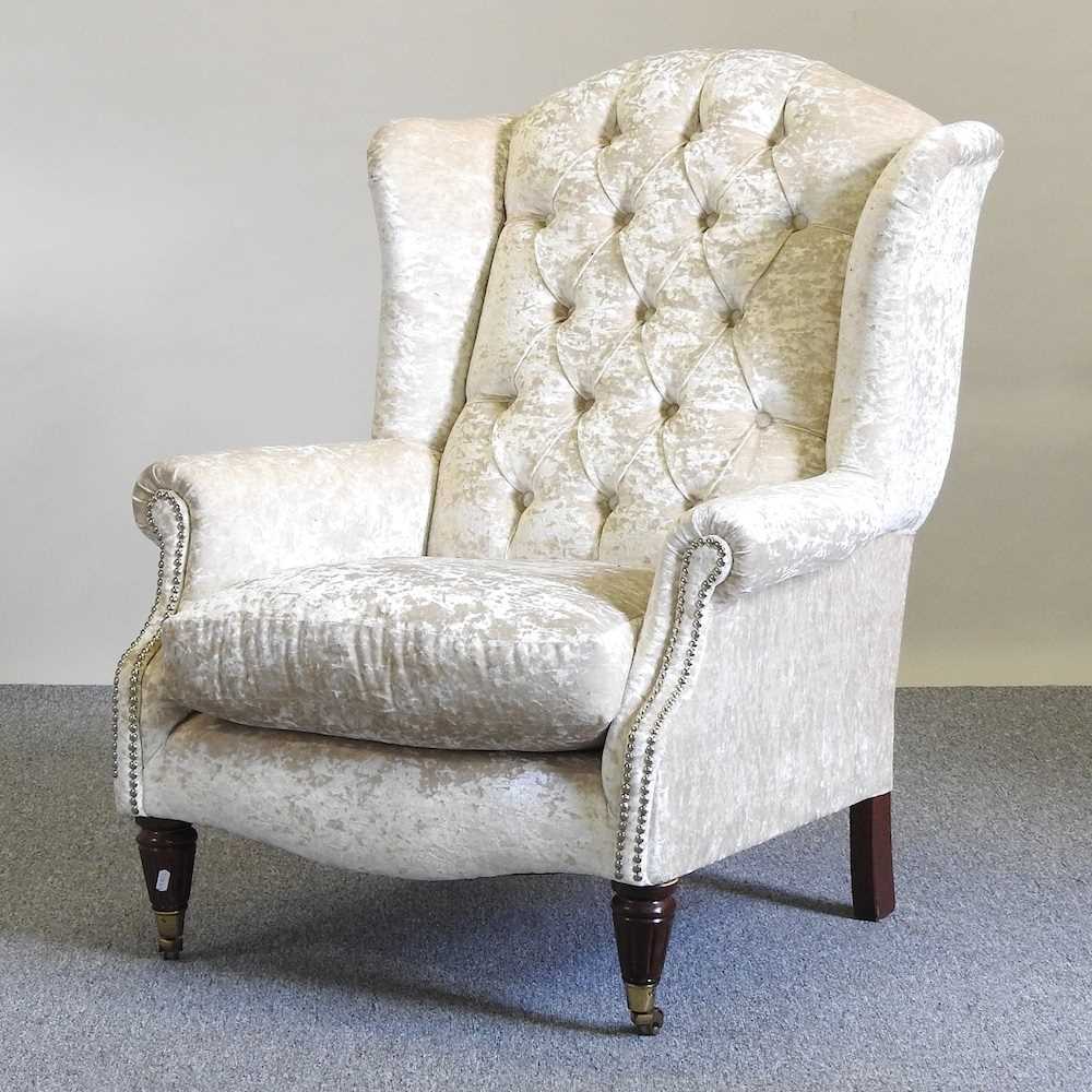 Lot 20 - An upholstered armchair