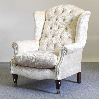 Lot 20 - An upholstered armchair