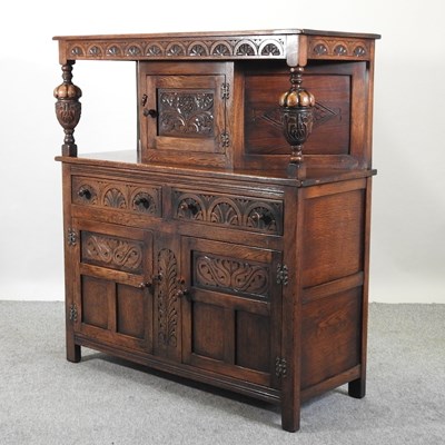 Lot 576 - A carved oak court cupboard