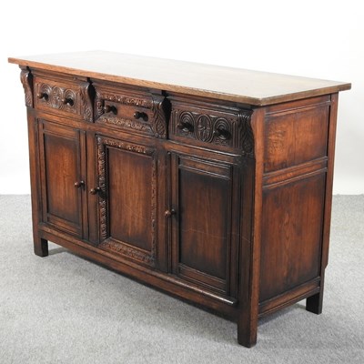 Lot 565 - A carved oak sideboard