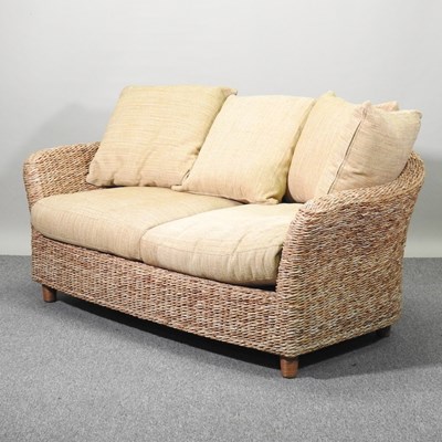 Lot 244 - A rattan sofa