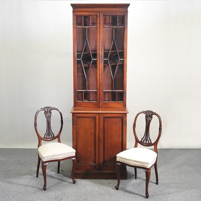 Lot 520 - A bookcase and chairs