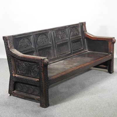 Lot 427 - An 18th century and later carved oak settle