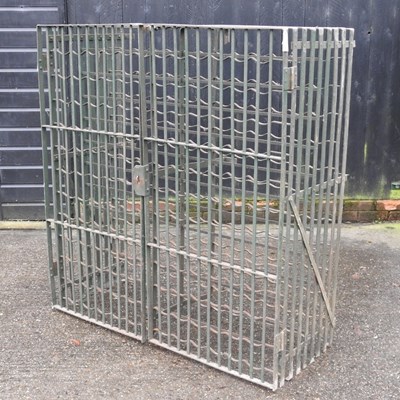 Lot 304 - A green painted iron wine rack