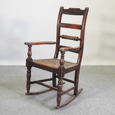 Lot 611 - A 19th century rush seated rocking chair