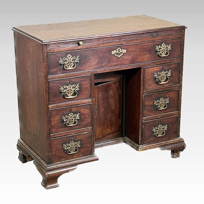 Lot 195 - A George III and later kneehole desk