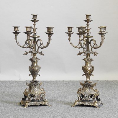 Lot 630 - A pair of ornate 19th century brass five branch candelabra