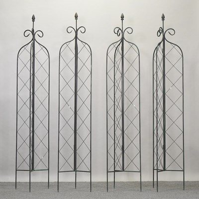 Lot 333 - A set of four metal folding lattice garden spires