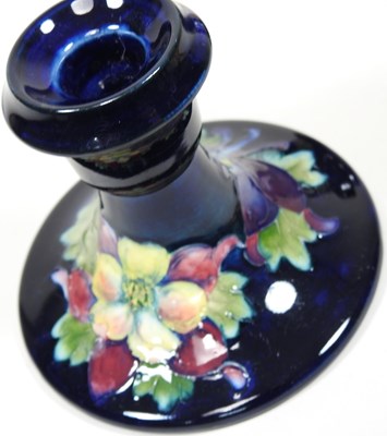Lot 101 - A Moorcroft pottery candlestick and vase