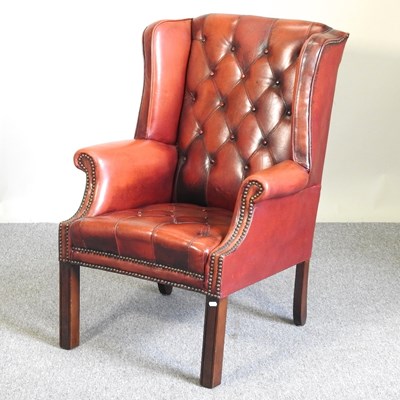 Lot 6 - A red leather upholstered button back armchair