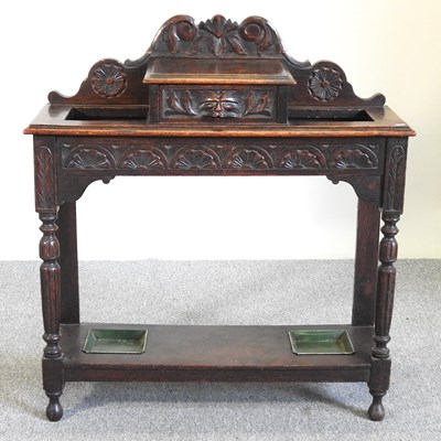 Lot 334 - A carved oak hall stand