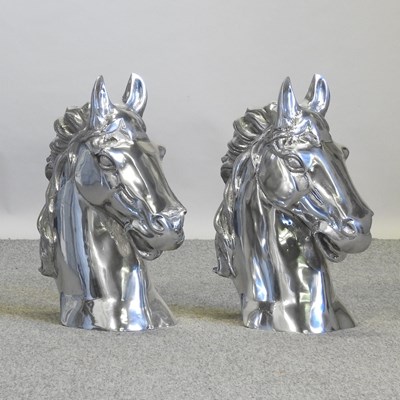 Lot 595 - A pair of large polished aluminium horses heads
