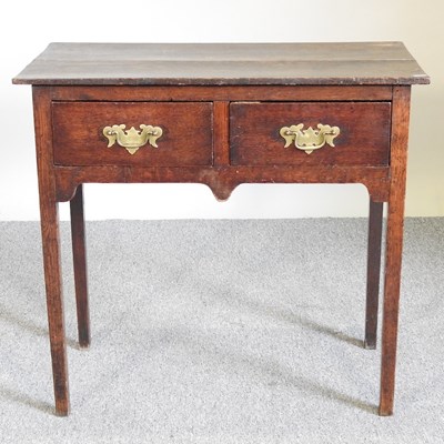 Lot 554 - A 19th century oak lowboy