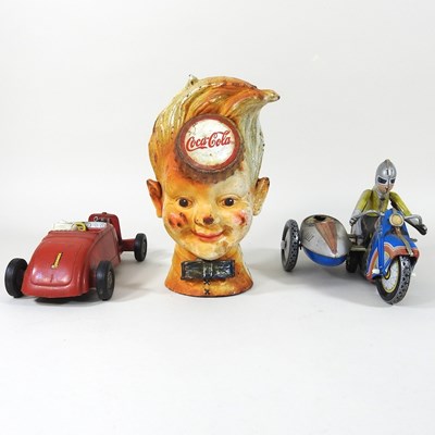 Lot 544 - A money box and toys