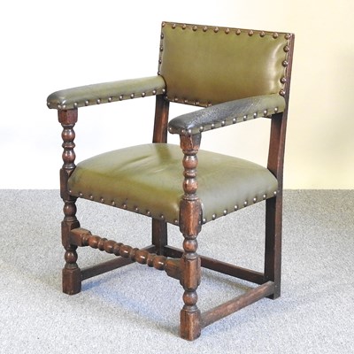 Lot 455 - A green studded armchair